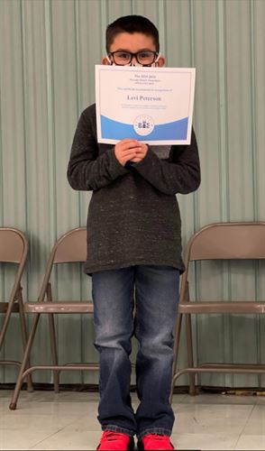 Student receiving a spelling bee award